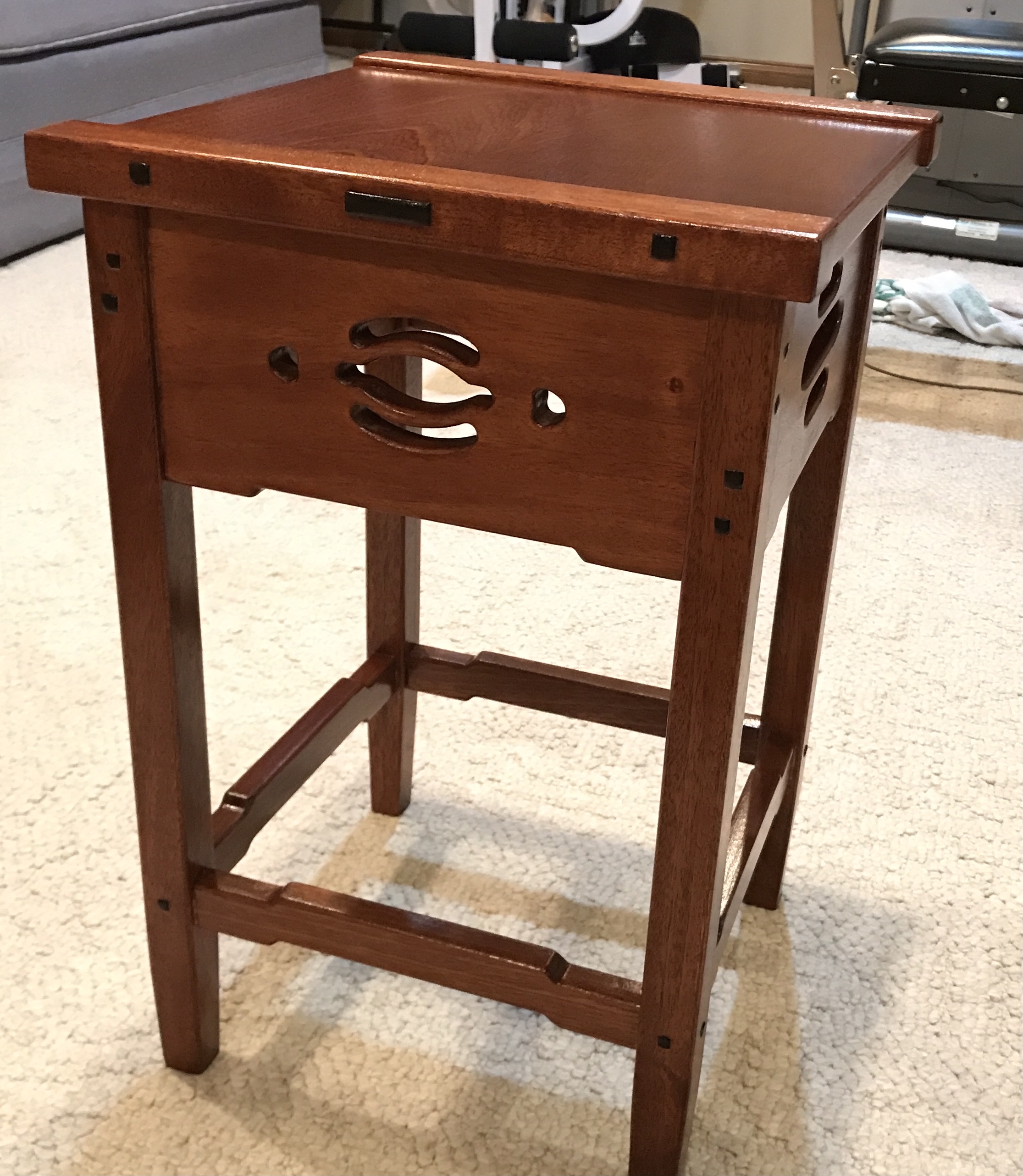 The varnished table top sitting on the legs